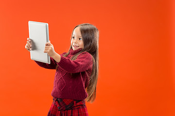 Image showing Teen girl with laptop. Love to computer concept. Attractive female half-length front portrait, trendy studio backgroud.