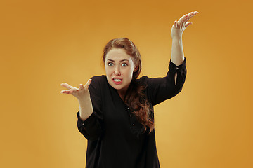 Image showing Beautiful female half-length portrait isolated on studio backgroud. The young emotional surprised woman