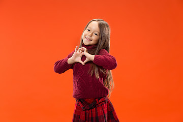 Image showing Beautiful smiling teen girl makes the shape of a heart with her hands