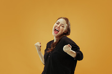 Image showing Winning success woman happy ecstatic celebrating being a winner. Dynamic energetic image of female model