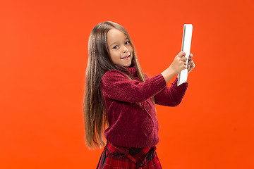 Image showing Teen girl with laptop. Love to computer concept. Attractive female half-length front portrait, trendy studio backgroud.