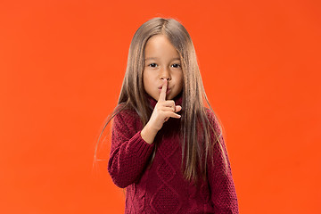 Image showing The young teen girl whispering a secret behind her hand