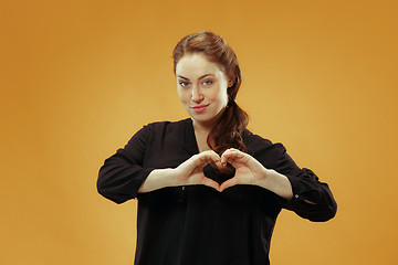 Image showing Portrait of attractive cute girl with bright makeup with kiss isolated over studio background