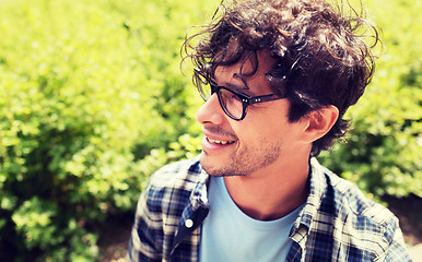 Image showing close up of smiling man in eyeglasses outdoors