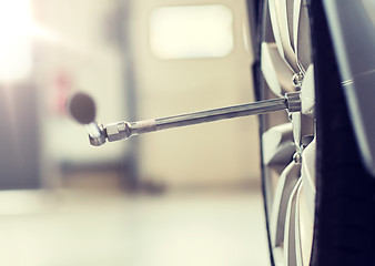 Image showing screwdriver and car wheel tire