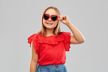 Image showing smiling preteen girl with heart shaped sunglasses