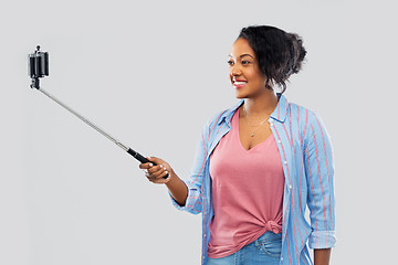 Image showing african american woman taking selfie by smartphone