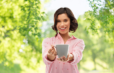 Image showing happy young woman in pajama with mug of coffee