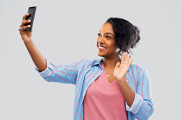 Image showing african american woman taking selfie by smartphone