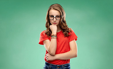 Image showing student girl in glasses thinking over green board