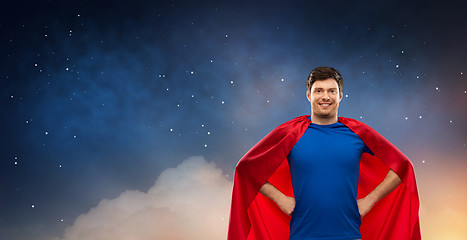 Image showing man in red superhero cape over night sky