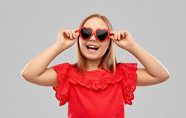 Image showing happy preteen girl with heart shaped sunglasses