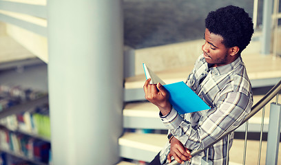 Image showing african student boy or man reading book at library