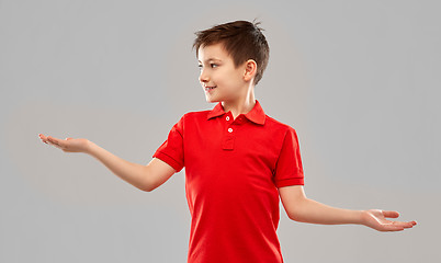 Image showing smiling boy holding something on empty hands