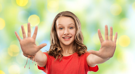 Image showing happy teenage girl in red t-shirt giving high five