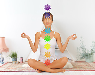 Image showing woman in lotus pose doing yoga with seven chakras