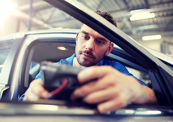 Image showing mechanic man with diagnostic scanner at car shop