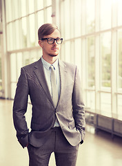 Image showing young businessman in suit and glasses at office