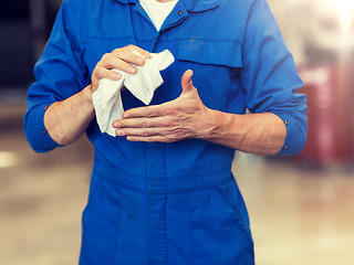 Image showing mechanic man or smith with wipe at car workshop