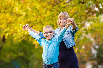 Image showing Mom and son seven-year-old son having fun in autumn park