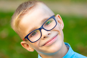 Image showing Portrait of a close-up of a cheerful boy with glasses