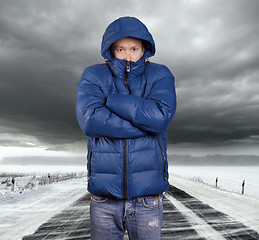 Image showing Asian man stand on snow road in winter