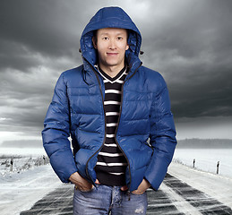 Image showing Asian man stand on snow road in winter