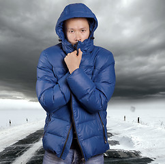 Image showing Asian man stand on snow road in winter