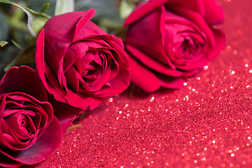 Image showing Roses over red abstract background with bokeh