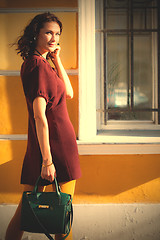 Image showing smiling woman in a burgundy dress