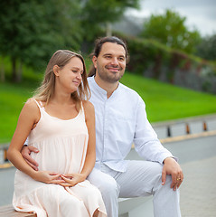 Image showing Pregnant woman and young father outdoor