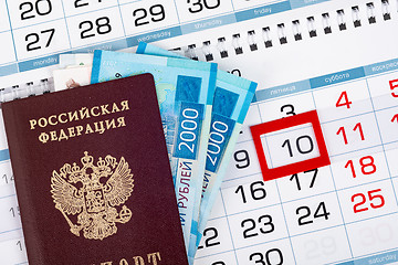 Image showing Passport and two 2,000 bills are on the calendar