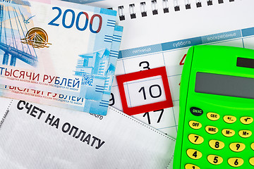 Image showing The calendar is allocated the number 10, there is a bill for payment, money and calculator