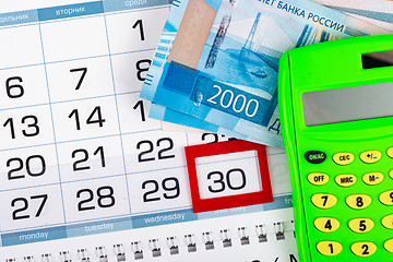 Image showing Calendar with a allocated 30 number, Russian two two-thousand bills, calculator