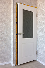 Image showing installed new white door in the interior of the room