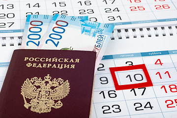 Image showing On the calendar with the marked 10 number is a passport and two 