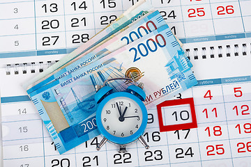 Image showing Calendar with a dedicated 10 number, a pack of Russian money and a clock