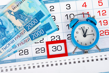 Image showing Calendar with a dedicated 30 number, a pack of Russian money and a clock