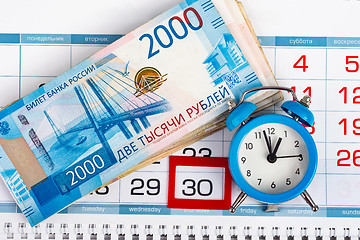 Image showing Calendar with a dedicated 30 number, a big pack of Russian money and a clock