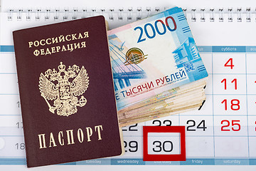 Image showing Passport and a large pack of Russian rubles are on the calendar with a dedicated number 30