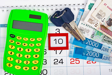 Image showing Calendar with the number 10, calendar, calculator, bunch of keys and a pack of Russ rubles