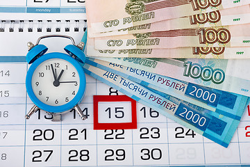 Image showing Calendar with a dedicated 15 number, a pack of Russian money and a clock