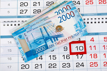 Image showing On the calendar with the number 10 is a pack of Russian rubles