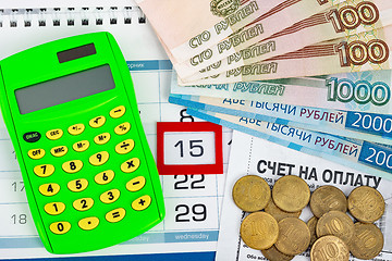 Image showing Calendar with a dedicated 15 number, calculator, Russian rubles banknotes and coins