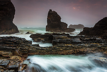 Image showing Raging waters over and around jagged craggy coastal rocks