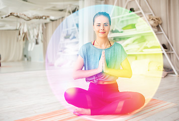 Image showing woman meditating in lotus pose at yoga studio