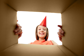 Image showing happy birthday girl in party hat opening gift box