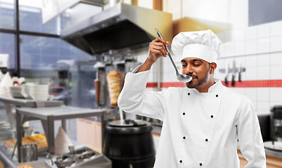 Image showing indian chef tasting food from ladle at kebab shop