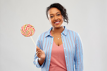 Image showing happy african american woman with big lollipop