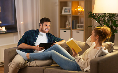 Image showing couple with tablet computer and book at home